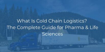 A blue semi-truck with a white trailer drives on a road near pine trees and hills. Overlaid text reads: What Is Cold Chain Logistics? The Complete Guide for Pharma & Life Sciences.